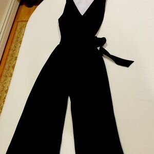 Black jumper wide leg ankle length. Back zip size 6 with waist tie.